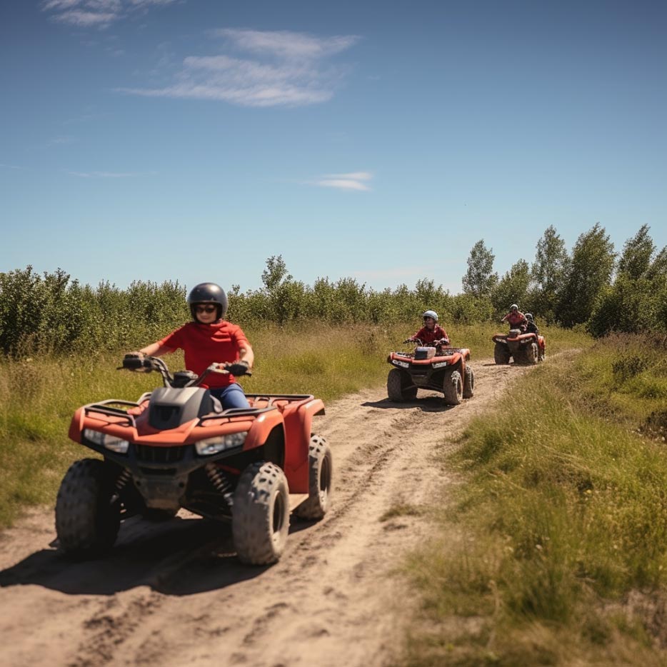 A family riding ATVs on a trail