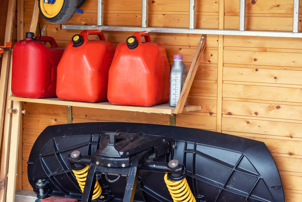 Garage corner with three red plastic fuel cans